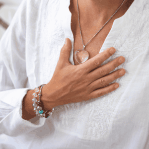 Person placing a hand on their heart during a trauma-informed grounding practice