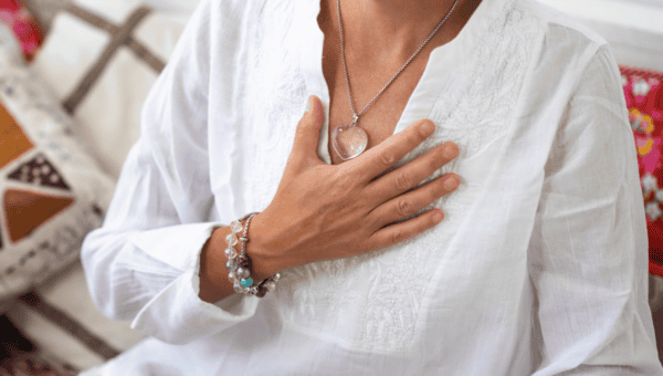 Person placing a hand on their heart during a trauma-informed grounding practice