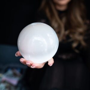 Anne-Marie mayers creator of Quantum Holographic Echo Healing holding a glowing crystal sphere symbolising quantum holographic echo healing and energy based healing