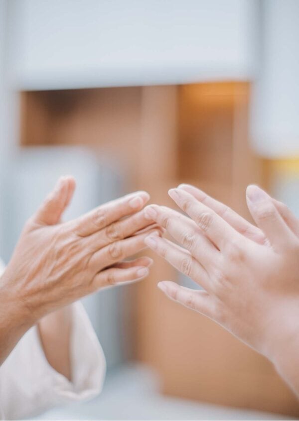 Hands in an mindful gesture during a meditation practice, representing calmness and connection - featured in the Meditation Teacher Toolkit Course.
