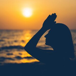 woman meditating at sunset - accredited spiritual life coaching course by Soul Awakening Academy UK, integrating meditation, mindfulness, chakras, and trauma-informed coaching with online certification.