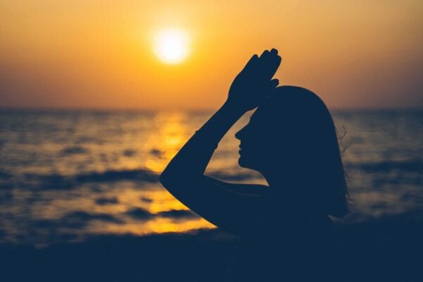 woman meditating at sunset - accredited spiritual life coaching course by Soul Awakening Academy UK, integrating meditation, mindfulness, chakras, and trauma-informed coaching with online certification.