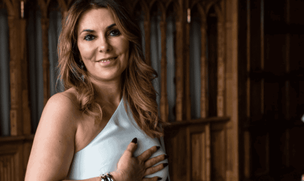 Anne-Marie smiling in a peaceful setting — trauma and relationship psychology coach training at Soul Awakening Academy.