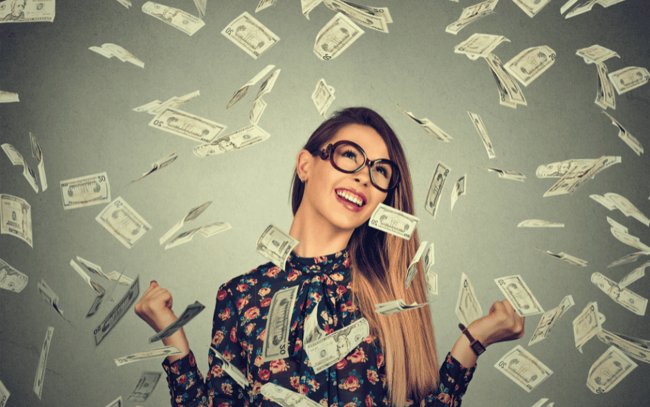 Woman celebrating financial success, symbolising business astrology money potential – Soul Awakening Academy.